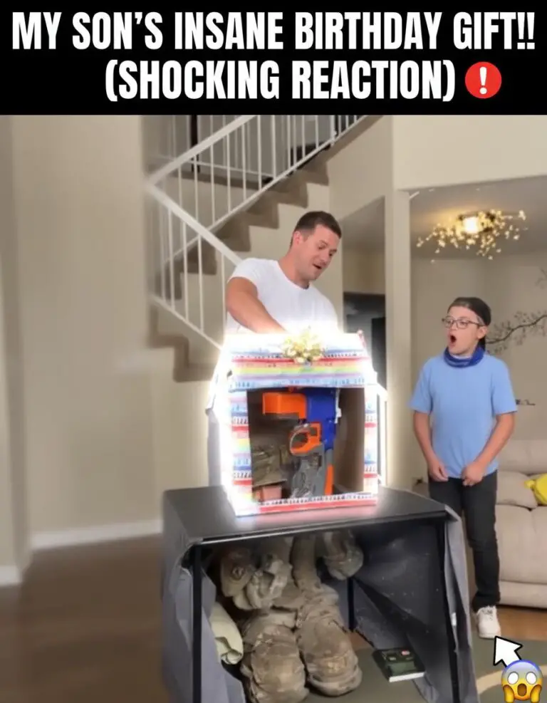 Military mother hugging her crying son in a school classroom during a surprise reunion